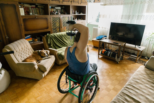 Disabled Man Weight Lifting At Home
