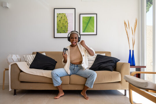 Victorious woman celebrating win in videogame