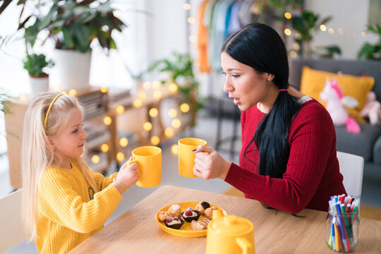 Girl and woman comparing hot drinks
