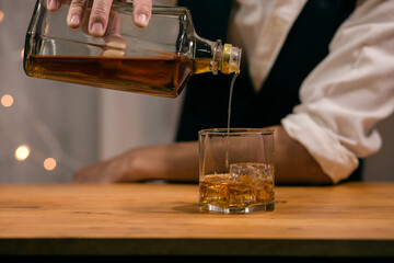 Barman pouring whiskey whiskey glass beautiful night