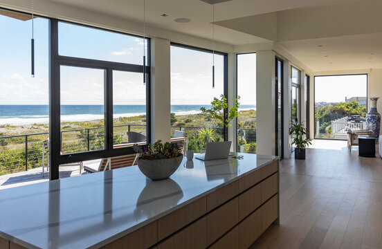 Fototapeta Laptop on kitchen island in Home by the Ocean