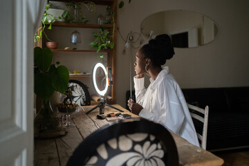 Profile Of Black Girl Making Up At Home.