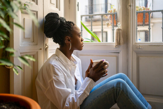 Cute Black Woman Warming Up Having A Hot Drink At Home