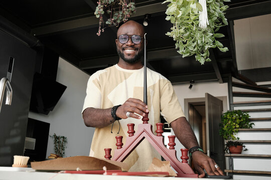 Black Man With Candles For Kwanzaa - Powered by Adobe