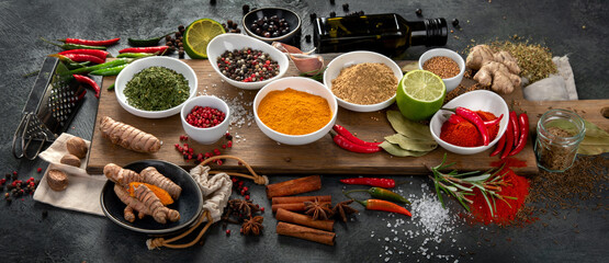 Assortment of spices on gray background.
