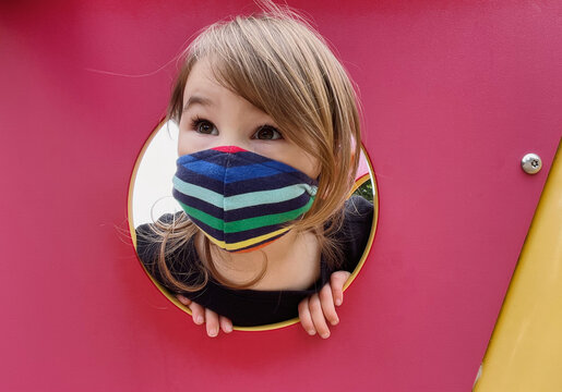 Child Wearing Mask Playing on School Playground