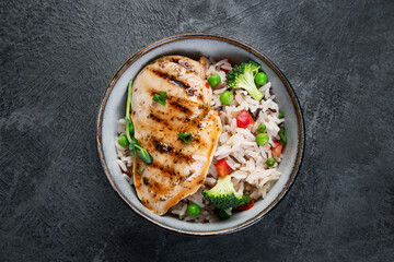 Grilled chicken with vegetables and rice.