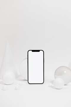 Smartphone with various geometric figures in studio