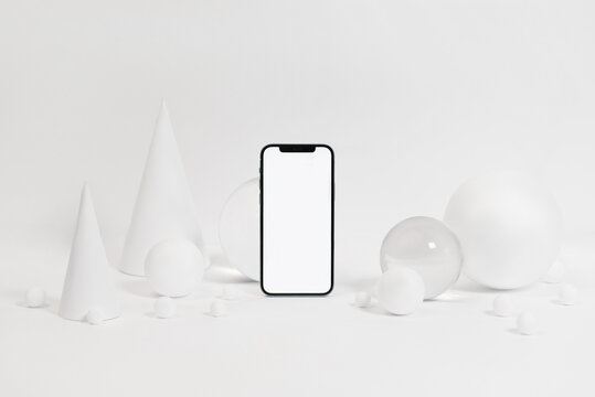 Smartphone with various geometric figures in studio