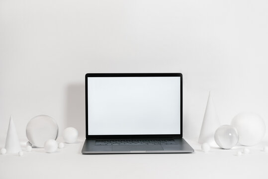 Laptop near geometric figures in studio