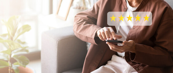 Customer pressing on smartphone with five stars icon for feedback review satisfaction service	

