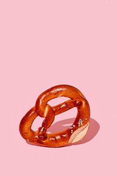 pretzel standing on a pink background