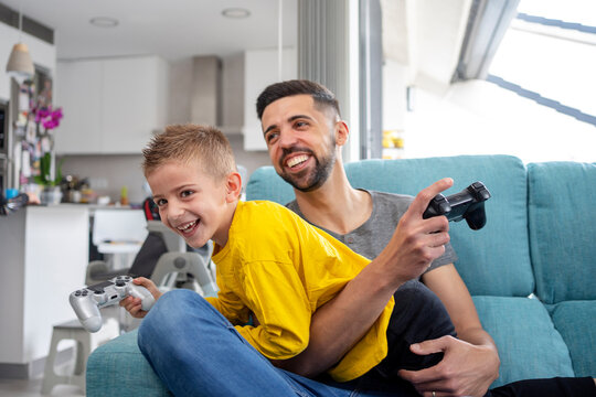 Cheerful Father And Son Playing Video Game