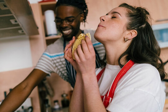 The woman eats homemade cookies.