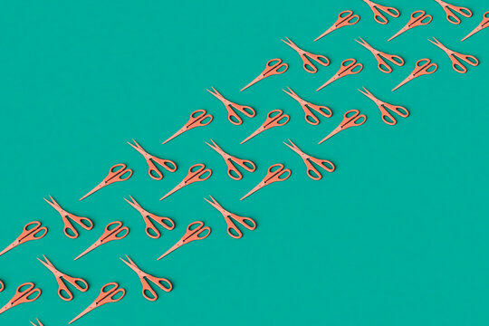 rows of Pink scissors on a green background