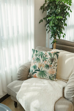A plant-patterned cushion on the sofa.