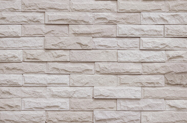 Cream and beige brick wall texture background. Brickwork and stonework flooring interior rock old pattern clean concrete grid uneven bricks office design. Background of old vintage brick wall backdrop