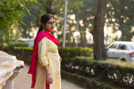 Indian woman with traditional dress standing beside road