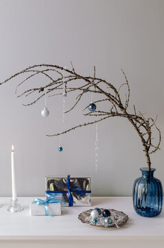 Composition with decorated larch branch and presents