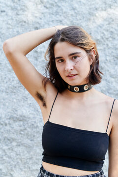 Young person showing unshaven armpit