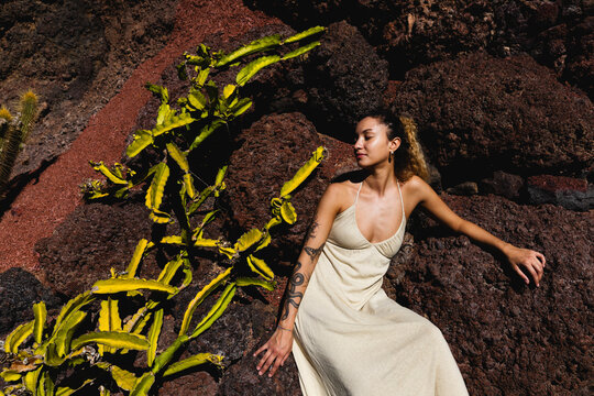 Girl sitting near the cactus