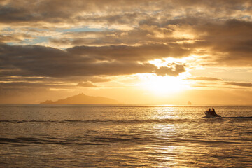 People in a recreational boat head out to sea