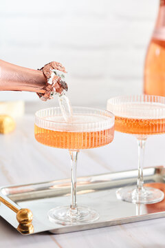 Pouring Pink Champagne From Bottle 