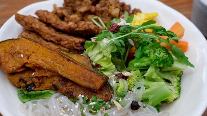 Close up of organic vegan meal with fresh and cooked eco vegetables and proteins, trendy healthy lifestyle