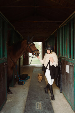 Woman in stables with her horse