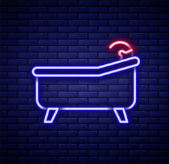 Glowing neon line Bathtub icon isolated on brick wall background. Colorful outline concept. Vector