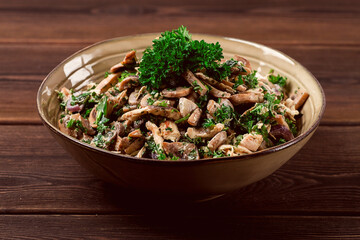 Chicken and mushroom salad, with herbs, seasoned with white sauce, close-up, rustic style,on a wooden table, toned,