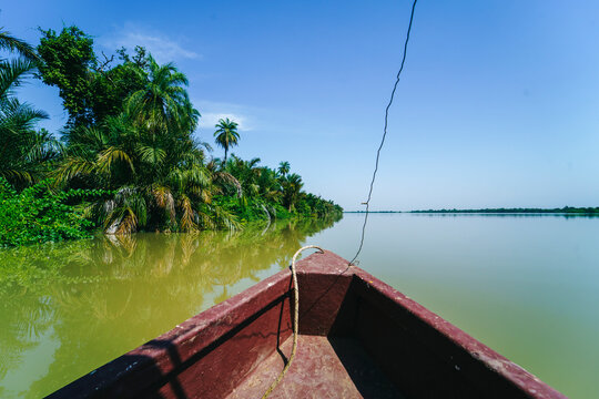 Boat on river in tropical jungle