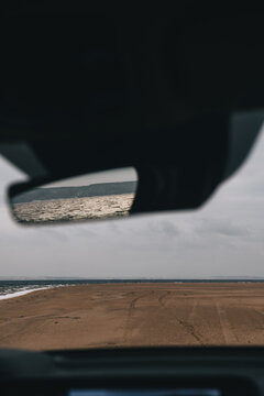 sea waves reflected in a car mirror