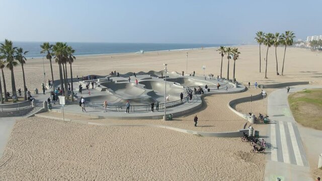 aerial view of people on a skate park in Venice beach California beautiful landscape with palm trees
