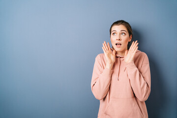 Young woman staring up in trepidation with mouth open