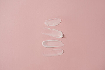 Close up of make up, skin care cosmetic product. Neutral white cream on pink background. Minimalist...