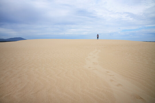 Person walking a sand dune