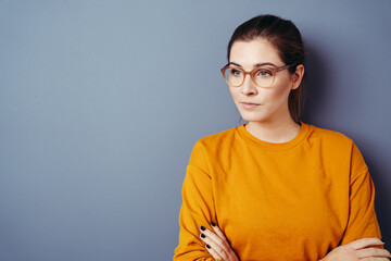 Serious worried young woman staring away to the side