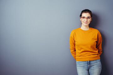 Trendy casual young woman wearing glasses and orange top