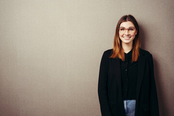 Cute young woman grinning happily at the camera