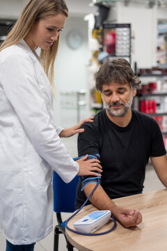 Practitioner measuring blood pressure of client