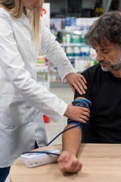 Practitioner measuring blood pressure of client