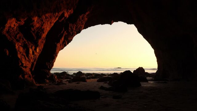 View of the ocean from inside a sea cave at Malibu California, El matador beach during golden hour
