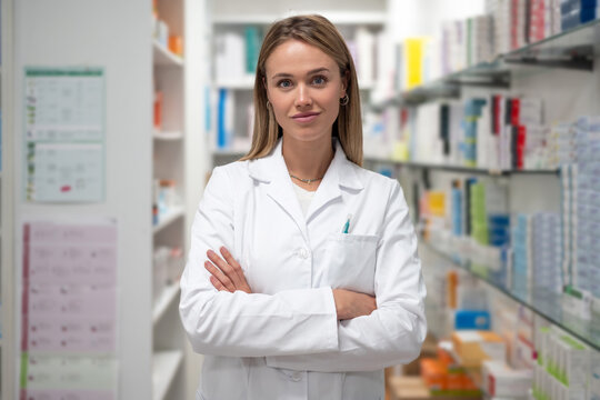Pharmacist folding hands in drugstore