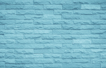 Brick wall painted with pale blue paint pastel calm tone texture background. Brickwork and stonework uneven design stack backdrop.