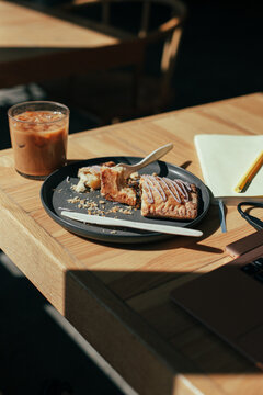 Working at a coffee shop with an iced latte and a poptart 