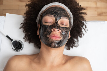 Close Up Of Woman With Black Carbon Face Mask 