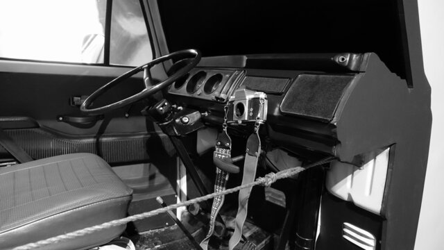 Turin, Italy - June 20, 2021: an antique camera hanging from the dashboard of an old truck at the Turin Automobile Museum.