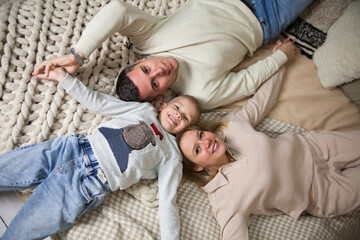 Family portrait of dad, mom and son on   bed
