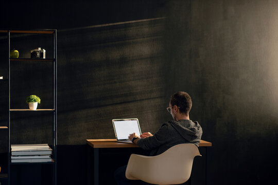 Young Man Typing On A Laptop